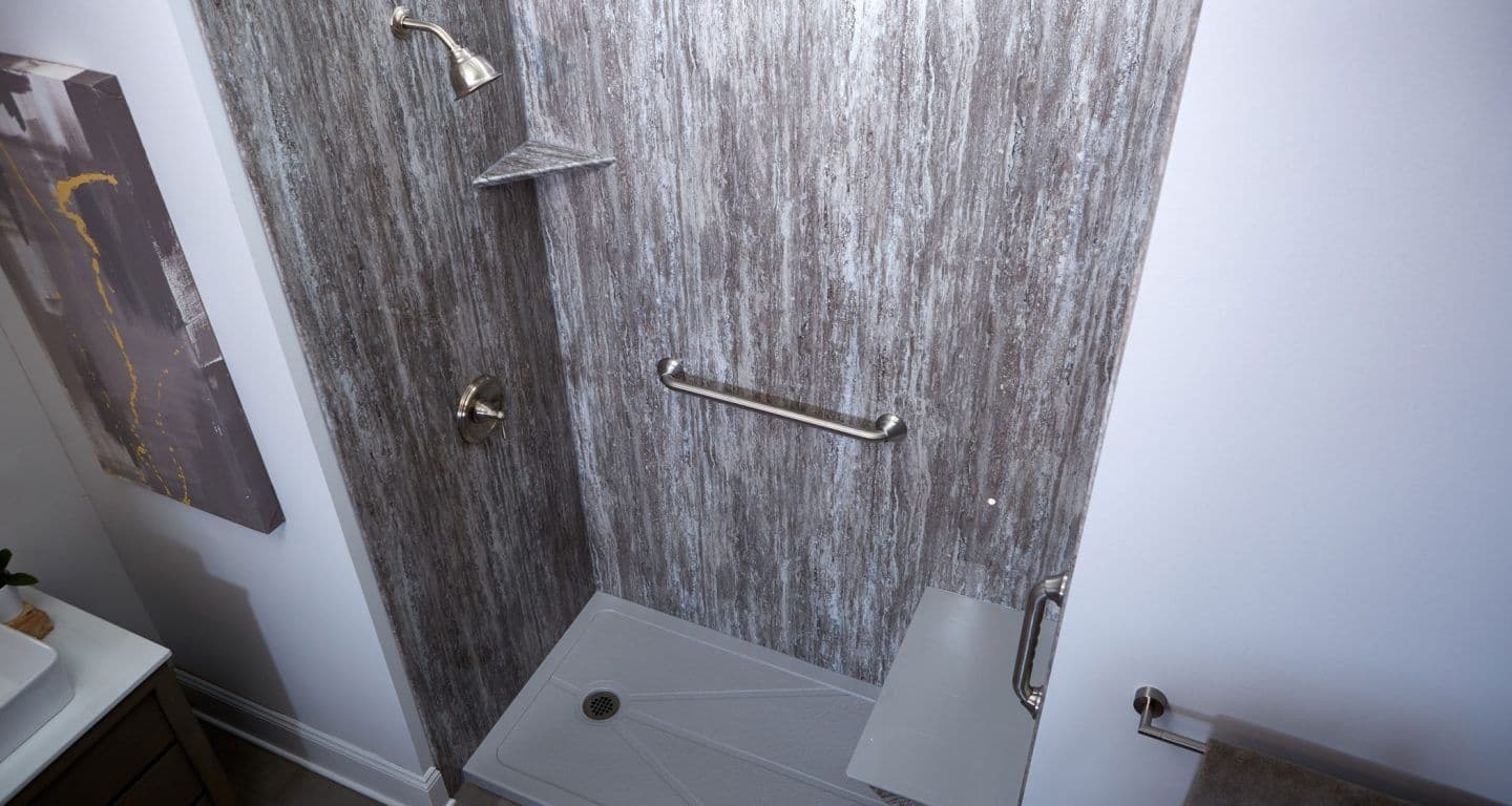 A BathWraps EasyStep Marble Cove Smooth Prairie shower with a built-in seat and a grab bar.